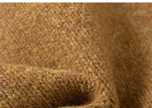 Detailed close-up of brown knit fabric texture showing high-quality wool yarn patterns