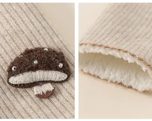 Detail of warm girls leggings featuring 3D mushroom embroidery and thick fleece lining