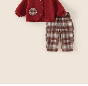 Close-up of red fleece winter jacket with plaid pockets and matching check trousers