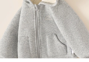 Close-up of a warm grey toddler zip-up hoodie featuring soft white fleece lining detail