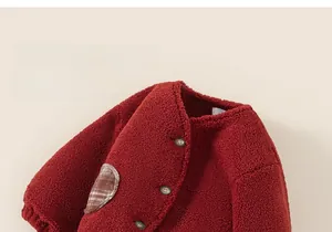 Detail of red fleece toddler jacket with vintage buttons and brown plaid pocket