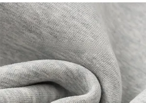 Detailed macro view of soft gray knitted fabric texture and warm fleece lining material