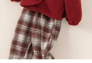 Detailed texture of kids burgundy fleece jacket paired with brown plaid warm trousers