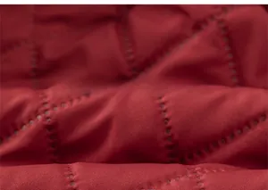 Detail of red quilted thermal fabric with point-stitch patterns for winter kids' clothing