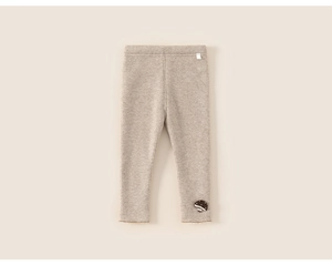 Close-up of ribbed knit texture and mushroom embroidery on beige toddler leggings