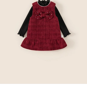 Detail of red tweed dress set featuring pearl bow and ruffled neckline for girls