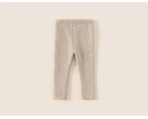 Detailed view of oatmeal ribbed knit texture and wave lettuce edge hem on girls leggings