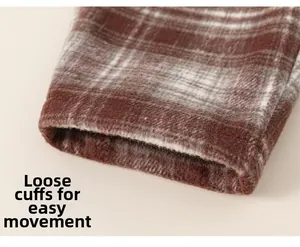 Close-up of brown plaid fleece pants showing the loose leg opening and thick fabric texture