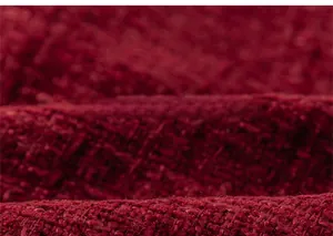Close-up of red tweed fabric texture for girl's elegant two-piece winter dress suit