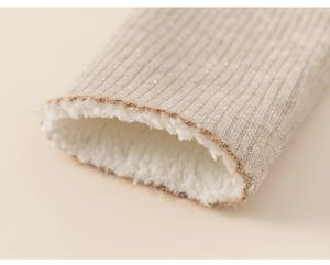 Macro detail of beige ribbed knit cuff with silver glitter and thick warm fleece lining