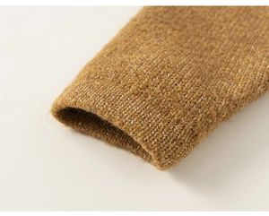 Close-up of mustard yellow knitted rib cuff detail showing wool blend texture and weave