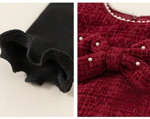 Detail of red tweed dress with plush ribbed cuffs and pearl-adorned bow decoration