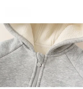 Detailed macro view of the warm fleece lining and high-quality zipper on the hooded jacket