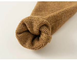 Detailed macro view of ginger yellow knit sweater cuffs showing thick elastic texture