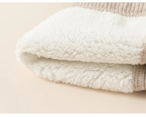 Detail of warm white fleece lining and knit fabric with shimmering silver silk threads