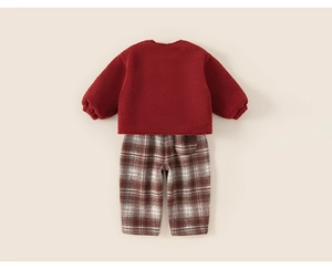 Flat lay of a red fleece sweatshirt and brown plaid trousers for kids' winter sets