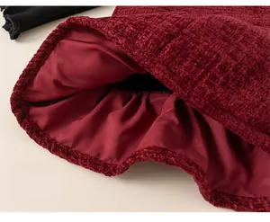 Detail of the wine red tweed dress showing the loose hemline and silky smooth inner lining