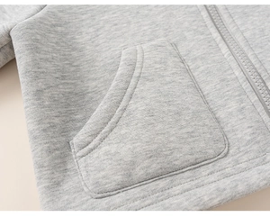 Close-up of heather grey fleece hoodie featuring a reinforced pocket and smooth zipper