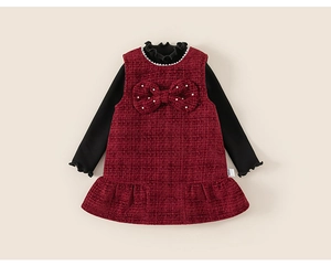 Close-up of girls tweed dress set featuring pearl accents and bow detail on vest