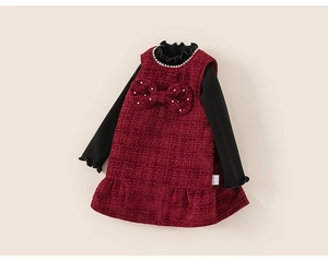 Detail of tweed dress set with burgundy texture, pearl accents and bow decoration