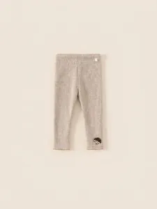 Beige ribbed thermal leggings for girls featuring mushroom embroidery and wavy hems