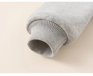 Detail shot of grey ribbed elastic cuffs on children's fleece-lined hooded jacket