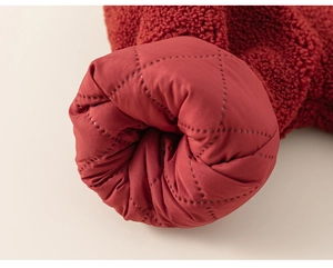 Detail of red sherpa jacket showing the plush texture and quilted diamond inner lining
