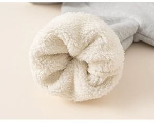 Detail of grey children's hoodie showing thick white sherpa fleece lining for warmth