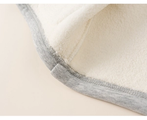 Detail of grey knit fabric with soft white sherpa fleece lining and flat seams