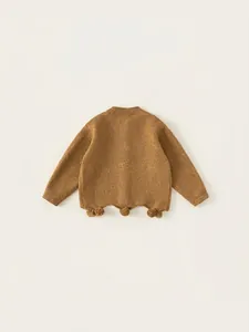 Cozy brown knit sweater for girls with wave hem and cute pompom details for autumn