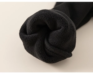 Macro shot of thick black fleece lining for warmth in toddler girl's winter outfit