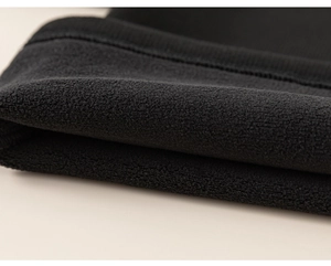 Close-up of thick thermal fleece lining on black children's outfit for winter warmth