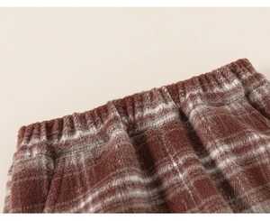 Detail of children's elastic waist pants in coffee brown and white checkered wool fabric
