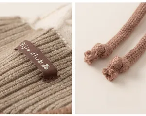 Detail of the soft knit texture, woven logo patch, and drawstring on children's earflap hat