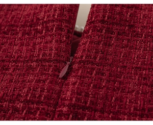 Macro view of dark red tweed fabric showing detailed weaving and seamless invisible zipper