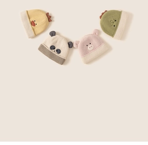 Flat lay detail of cute animal knitted hats for kids showing ribbed texture and ear designs