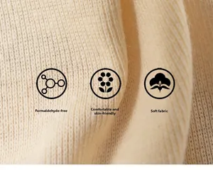 Macro detail of soft beige knit fabric showing high quality texture and skin-friendly material