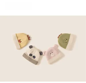 Detailed view of children's knit hats featuring cute duck, panda, pig and dinosaur designs