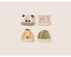 Flat lay of colorful knit toddler beanies with cute 3D animal ears and embroidered faces
