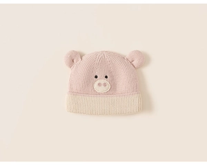 Detail shot of pink baby knit hat with cute 3D ears and soft animal face embroidery