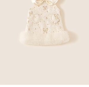 Close-up of girls princess dress featuring tweed texture and heart shaped pearl pockets