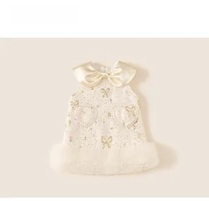 Detail of baby girl party dress with satin bow collar and pearl heart pockets