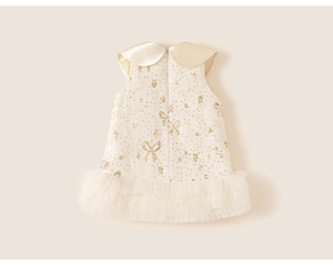 Detail view of toddler girl party dress with tweed texture and beige tulle skirt layering