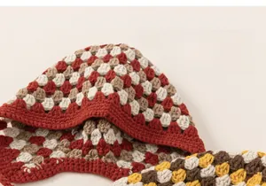 Detail of hand-crocheted hollow knit hat showing soft texture and colorful stitching