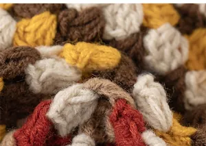 Close-up of thick multi-color knit texture in brown, beige, and yellow for kid's winter hat