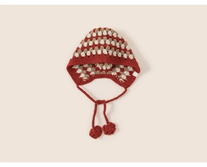 Detail of crochet knit baby earflap hat featuring colorful granny square pattern and ties