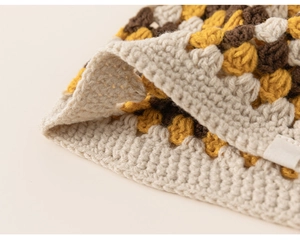 Detailed close-up of handmade crochet pattern and stitching on kids knit hat