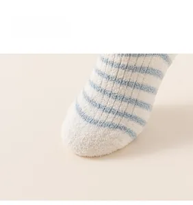 Close-up of thick blue and white striped coral fleece socks for toddlers