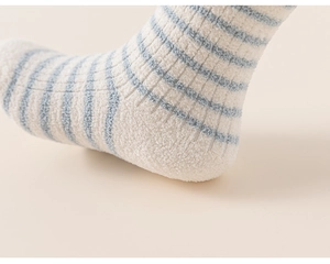 Close-up of thick striped thermal baby socks showing soft plush texture and ribbed cuff