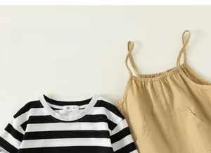 Close-up of kids striped long sleeve shirt and khaki suspender pants cotton fabric